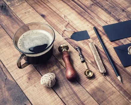 Vintage stationery elements on wooden table background.