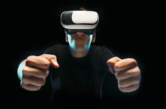 The man with glasses of virtual reality. Future technology concept. Black studio background