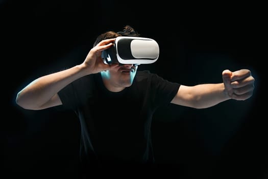 The man with glasses of virtual reality. Future technology concept. Black studio background