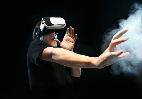 The man with glasses of virtual reality. Future technology concept. Black studio smoky background