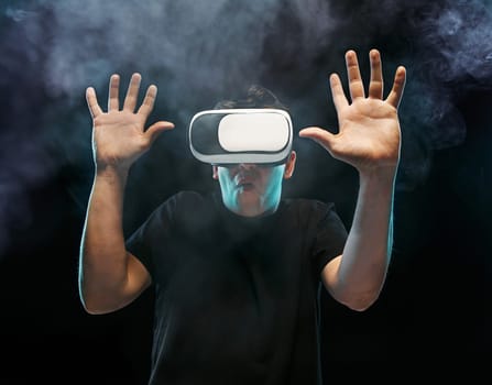 The man with glasses of virtual reality. Future technology concept. Black studio smoky background