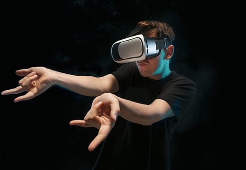 The man with glasses of virtual reality. Future technology concept. Black studio smoky background