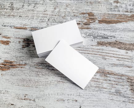 Blank white business cards on vintage wood background. Responsive design template with plenty of copy space.