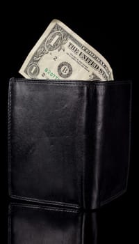 One Dollar Bill in Black Wallet on black background.