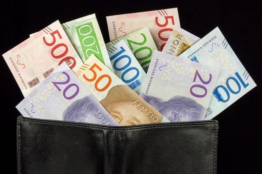 Wallet with Swedish Krona Currency on black background.
