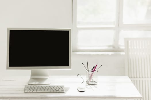 Stylish white workspace with computer on home or studio