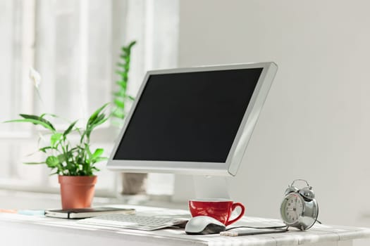Stylish white workspace with computer on home or studio
