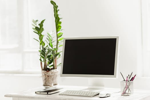 Stylish white workspace with computer on home or studio