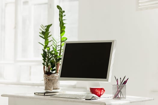 Stylish white workspace with computer at home or studio