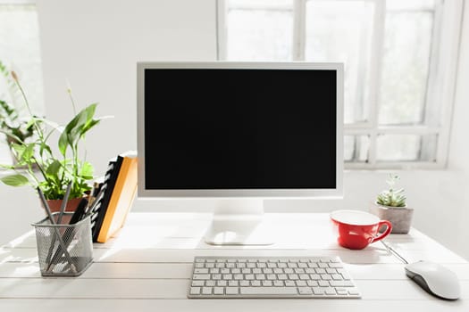 Stylish white workspace with computer on home or studio