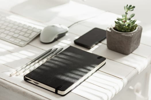 Office desk table with computer, supplies and mobile phone