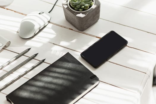 Office desk table with computer, supplies and mobile phone