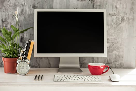 Stylish white workspace with computer at home or studio