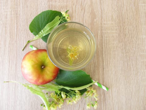 Freshly made lemonade with lime blossoms and apple juice