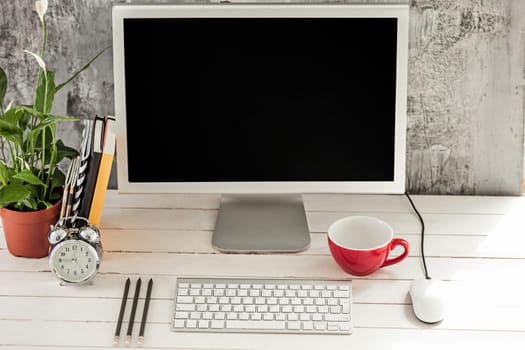 Stylish white workspace with computer at home or studio