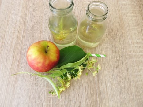 Freshly made lemonade with lime blossoms and apple juice