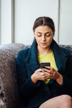 Young businesswoman is using her smartphone.