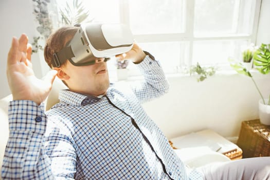 The man with glasses of virtual reality at home. Future technology concept.