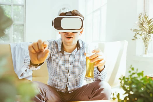 The man with glasses of virtual reality at home. Future technology concept.