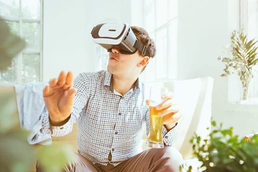 The man with glasses of virtual reality at home. Future technology concept.