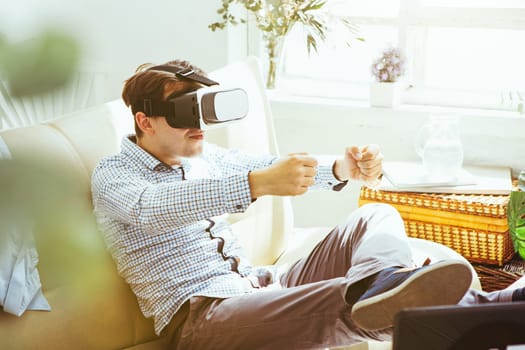 The man with glasses of virtual reality at home. Future technology concept.