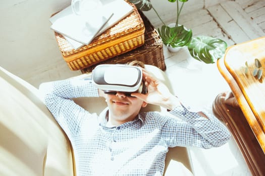 The man with glasses of virtual reality at home. Future technology concept.