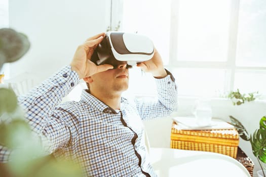 The man with glasses of virtual reality at home. Future technology concept.