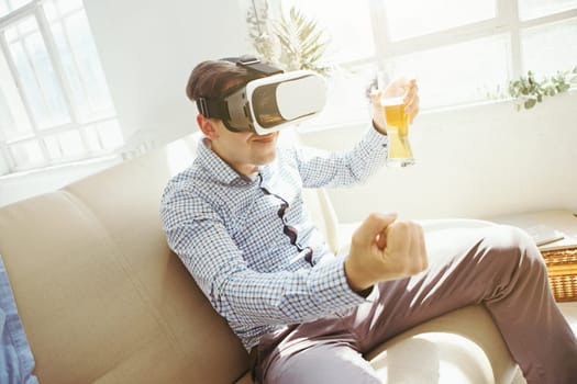 The man with glasses of virtual reality at home. Future technology concept.