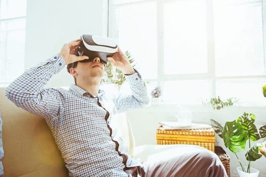 The man with glasses of virtual reality at home. Future technology concept.
