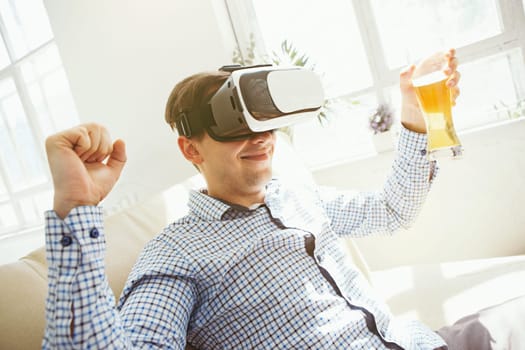 The man with glasses of virtual reality at home. Future technology concept.
