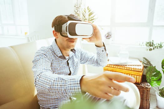 The man with glasses of virtual reality at home. Future technology concept.