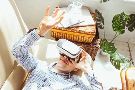 The man with glasses of virtual reality at home. Future technology concept.