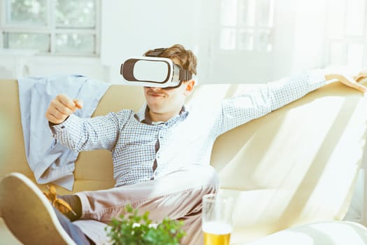 The man with glasses of virtual reality at home. Future technology concept.