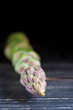 Wild green asparagus isolated on a black background