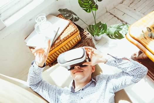 The man with glasses of virtual reality at home. Future technology concept.
