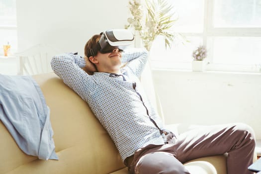 The man with glasses of virtual reality at home. Future technology concept.