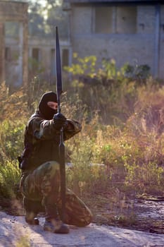 The soldier is shooting with bow and arrow.