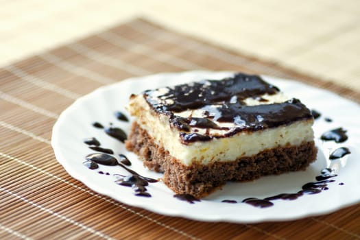 A part of chocolate cake is on white plate.
