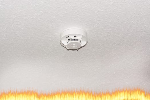Smoke detector on the ceiling with red warning light sensor and smoke..
