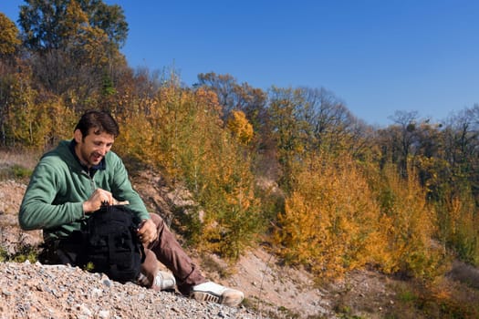 The mountaineer is resting in autumn nature.