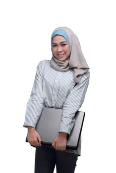 Beautiful asian muslim woman holding laptop isolated over white background