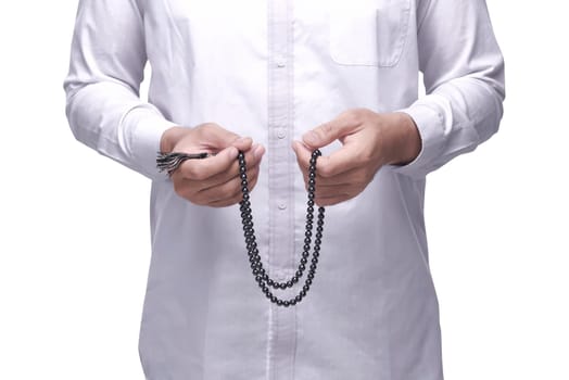 Muslim man praying with prayer beads isolated over white background