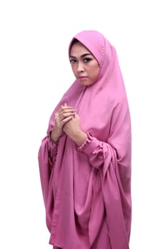 Beautiful asian muslim woman wearing veil praying isolated over white background