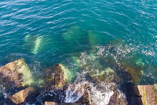 aerial view waves on a breakwater