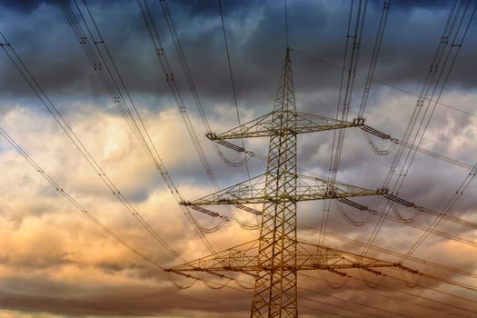 Electricity pylon or high-voltage line in the background a cloudy sky..