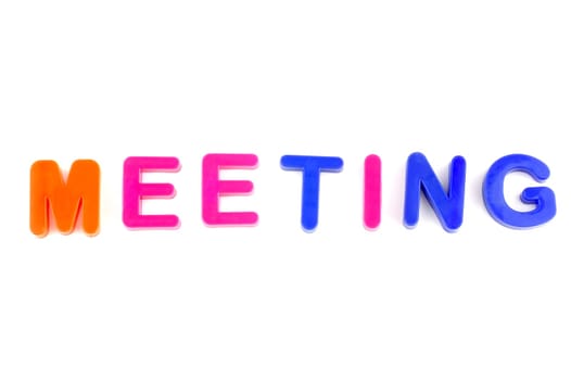 Word meeting isolated on white background made from colorful toys letters