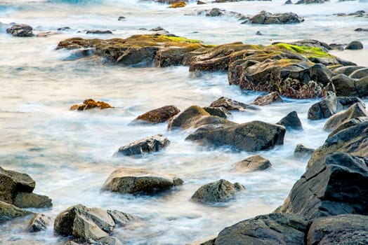 Surf of the Atlantic Ocean with rocks in long exposure