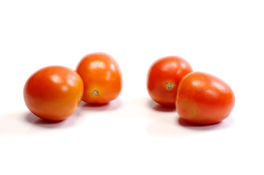 Four tomatoes on white background. Look tasty and fresh