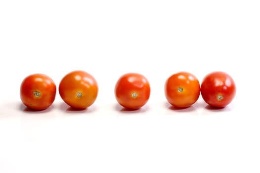 Five tomatoes on white background. Look tasty and fresh