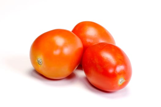 Three tomatoes on white background. Look tasty and fresh
